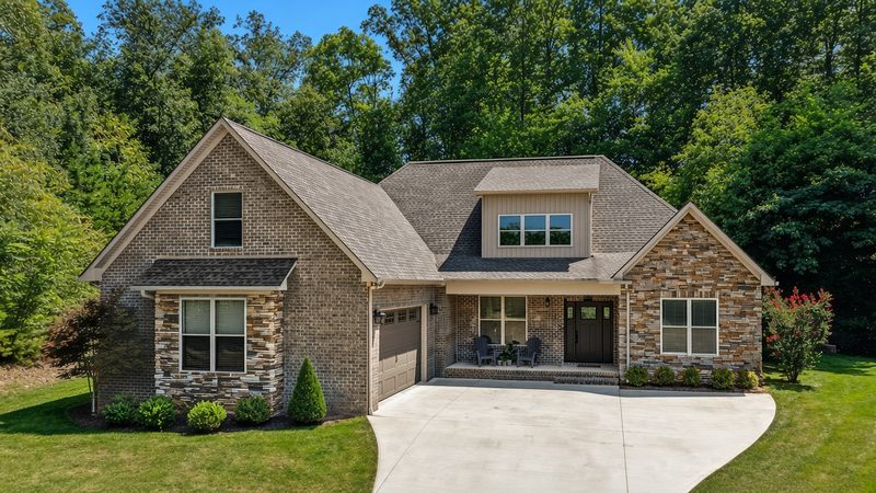 Rendering of a brick and stone craftsman home front elevation