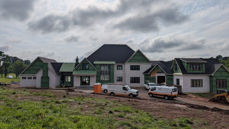 White brick estate home under construction