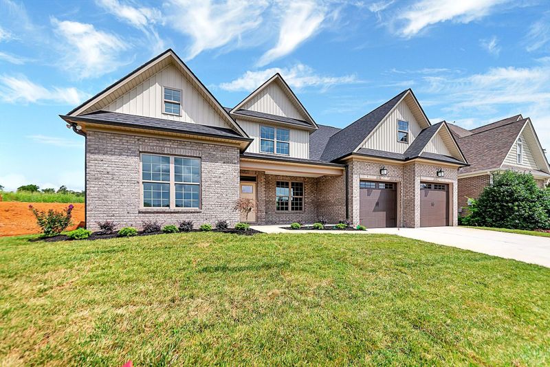 Brick craftsman home with layered gables and a covered front porch