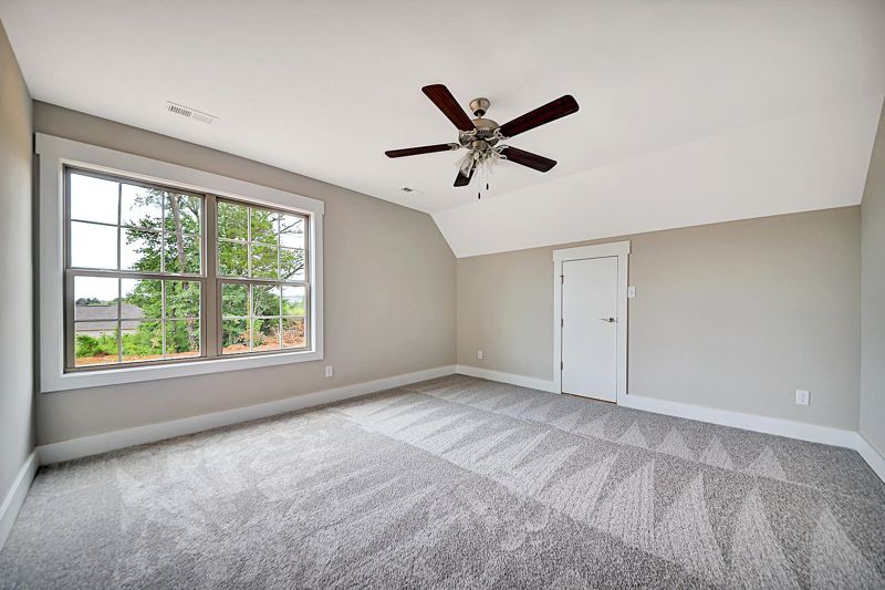 Upstairs bedroom with ceiling fan