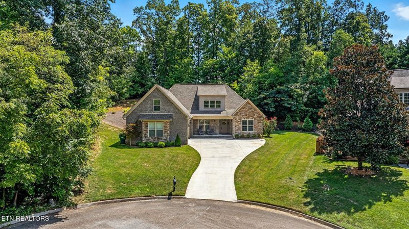 Custom home set back on a wooded lot with a curved driveway