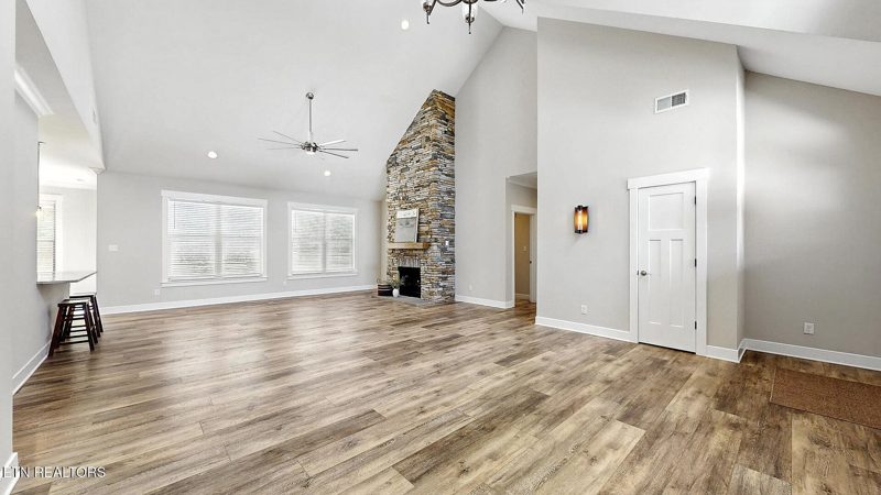 Great room with stone fireplace and natural light