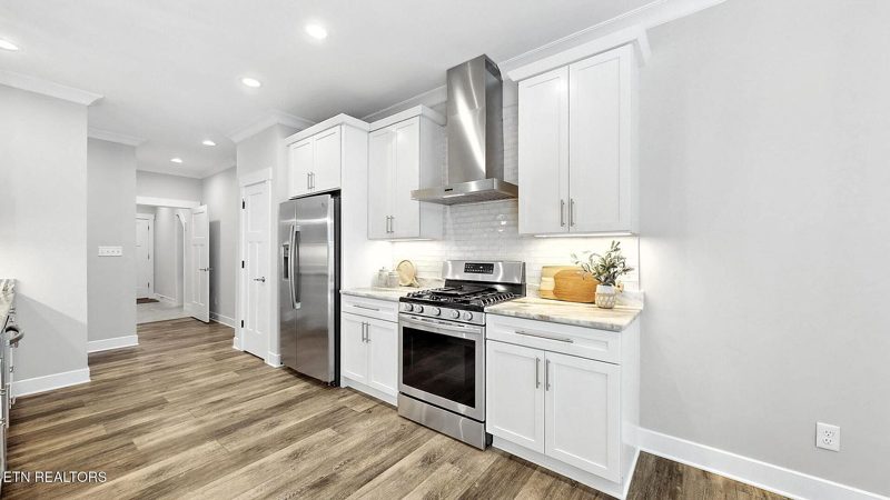 Kitchen with stainless appliances and white cabinetry