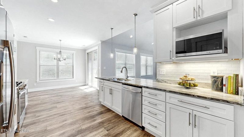 Kitchen sink beneath a window with granite counters