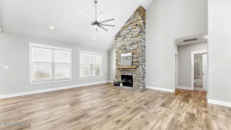 Bonus room with a stone fireplace