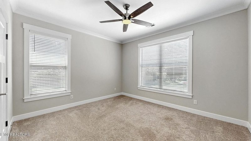 Bedroom with ceiling fan and natural light