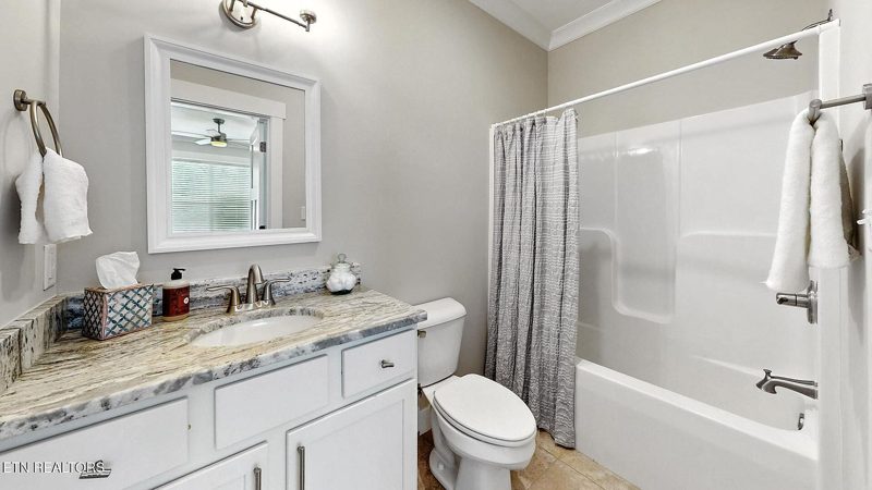 Bathroom with granite vanity and tub-shower
