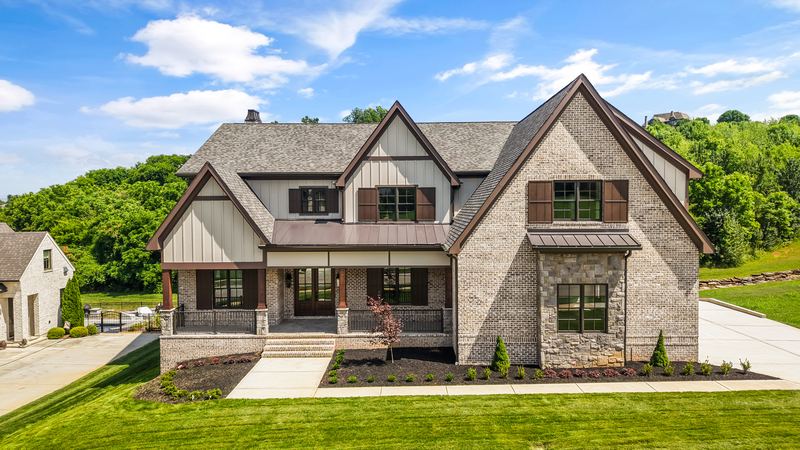 Custom home exterior in Knoxville: brick, stone and gabled rooflines