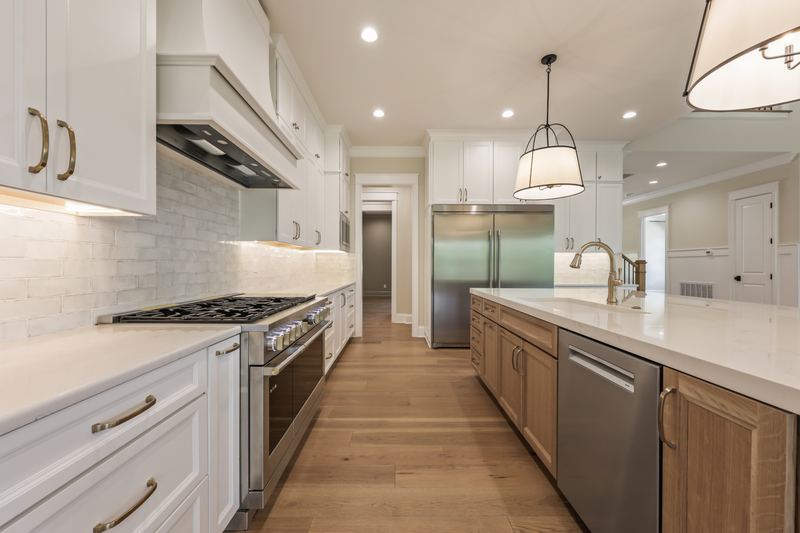 Kitchen with range hood and white cabinetry