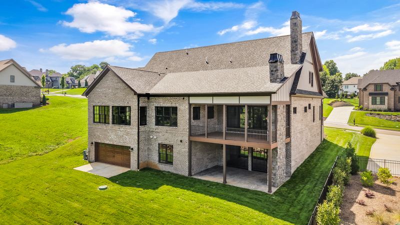 Rear exterior with covered porches and walkout lower level