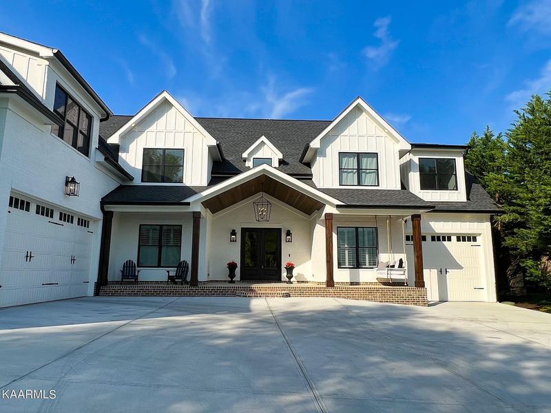 Modern farmhouse front elevation with three-car garage