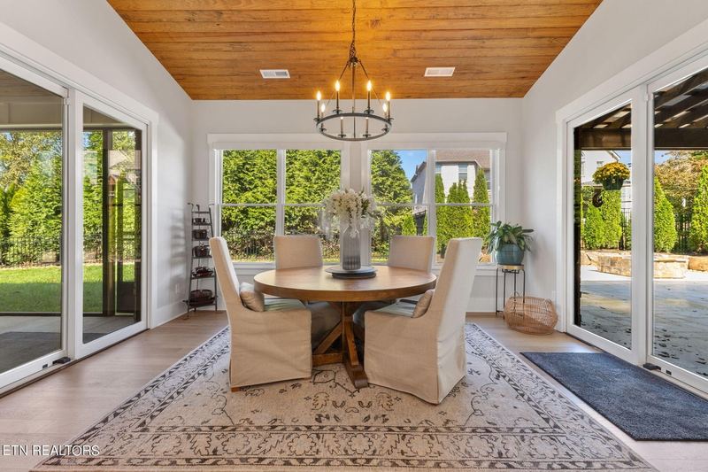 Dining area with wood ceiling and window wall